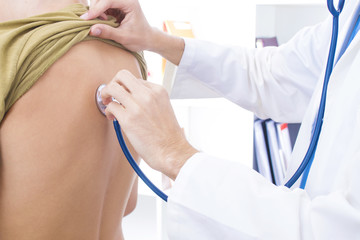 doctor with stethoscope listening to the patient