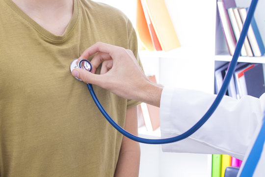 Doctor With Stethoscope Listening To The Patient