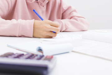 closeup of the hand of the child writing in the school