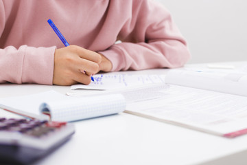 closeup of the hand of the child writing in the school