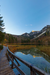 Reflection on Lake Frillensee, Inzell, Bavaria, Germany at sunset in fall with Mount Hochstaufen in Background