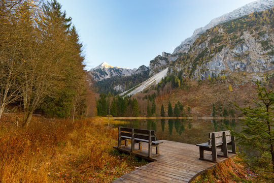Reflection on Lake Frillensee, Inzell, Bavaria, Germany at sunset in fall with Mount Hochstaufen in Background