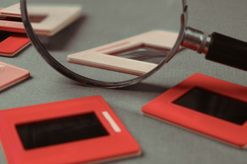 old slides and a magnifying glass on green table