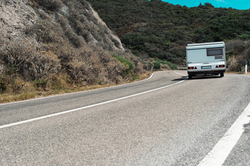 Motorhome driving on winding mountain road. Sardinia. Italy.