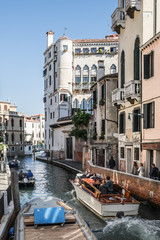 Streets in Venice with tourists, Venetian transport boat, Narrow side canal with boats in Venice Italy, Classic canal in Venice, Picturesque alley with water and boats in Italian Venice