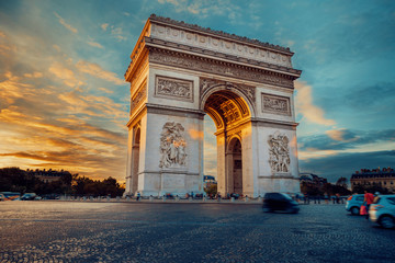 Famous Paris avenue Champs-Elysees and the Triumphal Arch, symbol of the glory on bright sunny day with cloudy sky. Iconic touristic landmark and romantic travel destinations in France. Long exposure - obrazy, fototapety, plakaty