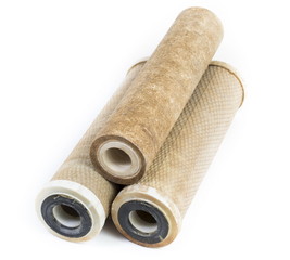 Dirty water filter cartridges on white background
