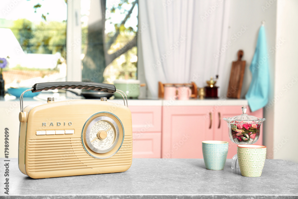 Wall mural retro radio on table in kitchen