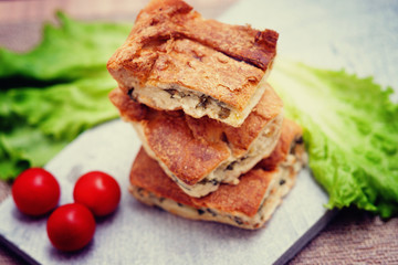 Pie with meat and fresh vegetables on plate 