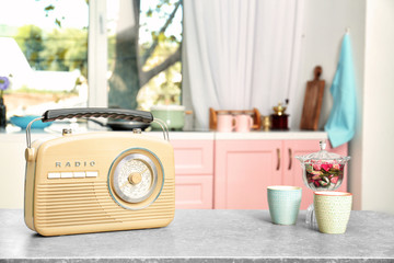 Retro radio on table in kitchen
