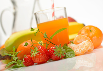fruit juice with ingredients around on white background