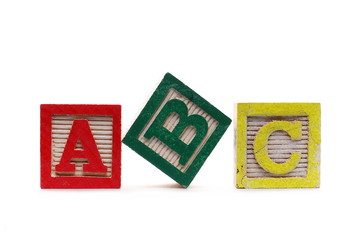 Wooden alphabet blocks A, B, C, isolated on white background