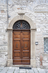 Fototapeta na wymiar Gubbio, Perugia, Italy - entrance door, architectural details of the ancient palaces