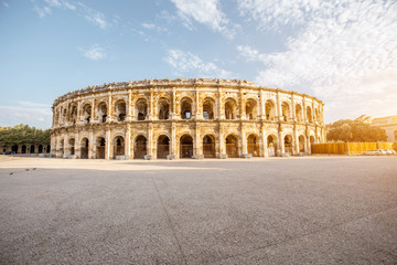 Morning view on the ancient Roman amphitheatre in Nimes city in the Occitanie region of southern...