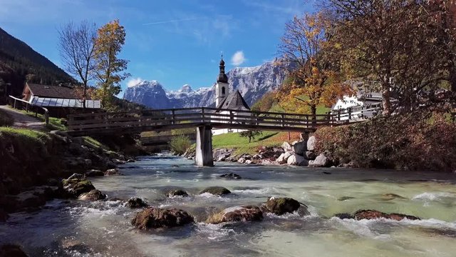View from river surface of famous Parish church St. Sebastian, in Ramsau, Berchtesgaden, Bavarian Alps, Germany.