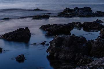 Fototapeta na wymiar Sea waves at night on long exposure