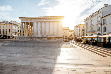 View on the ancient Roman temple Maison Carree during the sunny morning in Nimes in the Occitanie...