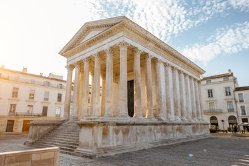 View on the ancient Roman temple Maison Carree during the sunny morning in Nimes in the Occitanie...