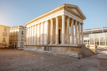 View on the ancient Roman temple Maison Carree during the sunny morning in Nimes in the Occitanie...