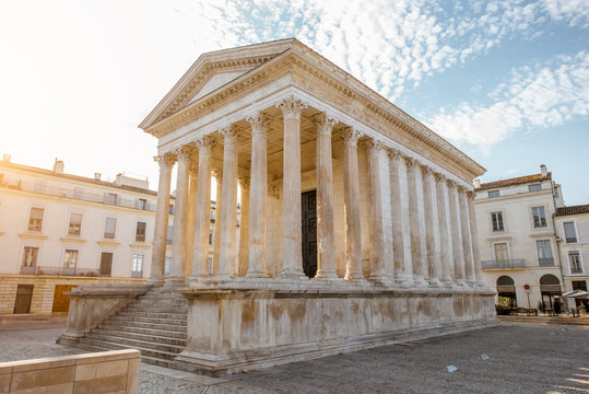 View on the ancient Roman temple Maison Carree during the sunny morning in Nimes in the Occitanie region of southern France