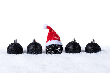 Five Black christmas balls with snow and Santa Hat isolated on white background