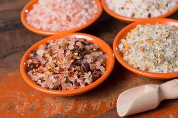 Variety of sea salt, pink Himalayan salt, colorful salt with dried chili pepper, herbs and spices.