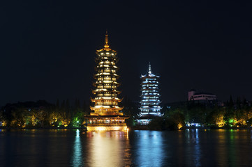 The Sun and Moon Twin Pagodas illuminated at nigh in the city of Guilin, China