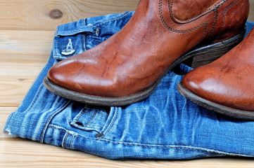 Brown cowboy boots on blue jeans