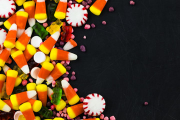 Colorful candies and  jelly on a black background background. Top view with copy space