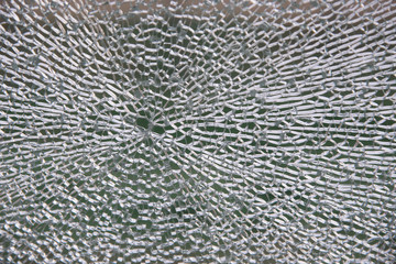 Double layer, hardened security glass surface with small glass pieces visible. Due to laminated technology the glass stands in one piece despite of being smashed.