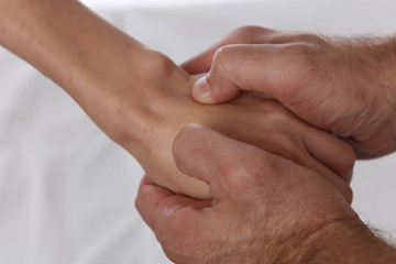 Woman suffering from hand joints pain having Chiropractic adjustment. Acupressure, Physiotherapy, sport injury rehabilitation concept