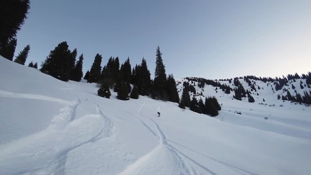 Extreme snowboarder woman riding by powder at mountain