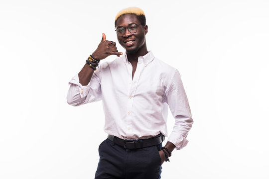 Happy young african man with calling gesture over white background