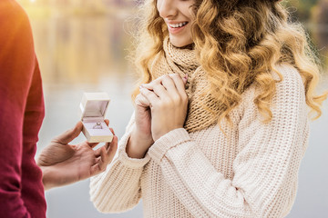 Will you marry me? Cropped image of young man giving engagement ring to his beautiful and happy...