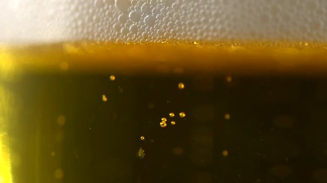 Cold beer in a glass with water drops. Closeup image. Craft beer. 4K UHD video 3840x2160