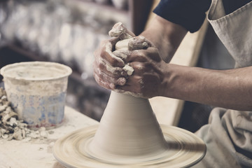 Potter makes pottery handmade in the workshop 