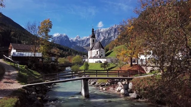 Flight over famous Parish church St. Sebastian, in Ramsau, Berchtesgaden, Bavarian Alps, Germany.