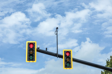 red traffic light at hanging lamp under  sky