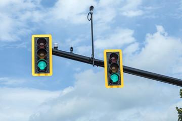 green traffic light at hanging lamp under  sky