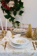 Elegant golden and white christmas table.