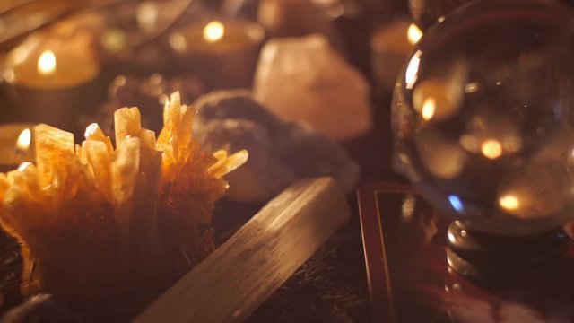 Voodoo conjurer occult mystic table reading setup with crystals