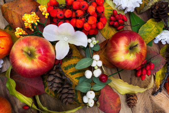 Fall table centerpiece with apples and white silk flowers, top view