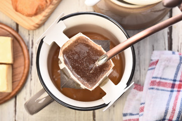 Instant freshly brewed cup of coffee on a wooden table
