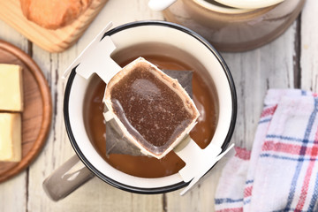 Instant freshly brewed cup of coffee on a wooden table