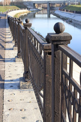 Cast iron fence along the embankment of the river