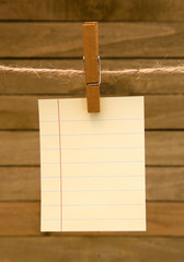 Naklejka na ściany i meble Background of Hanging Paper on a Wooden Background