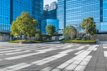 empty pavement and modern buildings in city.