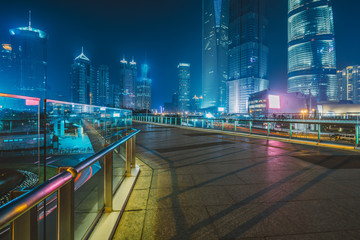 cityscape and skyline of shanghai from empty brick floor at night