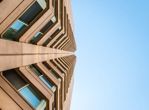 Abstract Image Of Looking Up At Modern Brick Concrete Glass Building. Architectural Exterior Detail Of Industrial Office Building. Industrial Art And Detail.