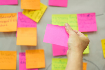 Close up hand holding empty note sticky for brainstorm strategy workshop business.Brainstorming concept.